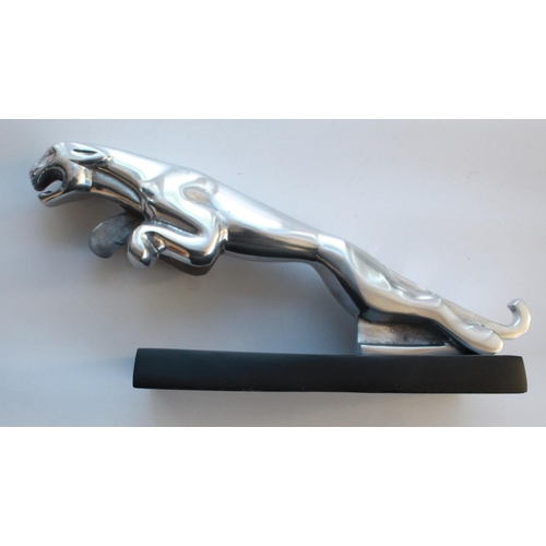 378 - Chrome Jaguar mascot on metal plinth. 38cm head to tail.