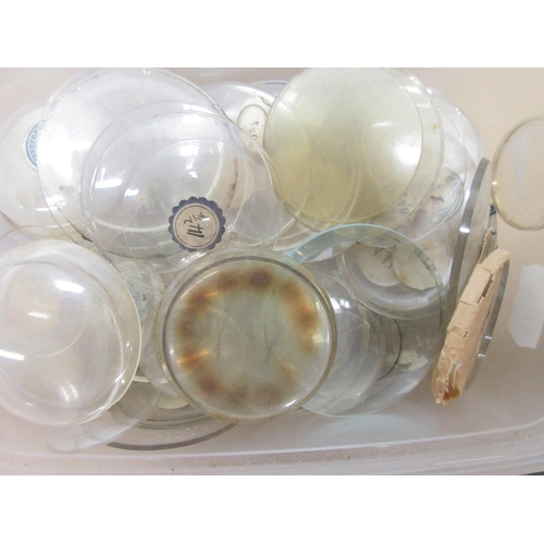 243 - Ten containers containing early 20th Century pocket watch and fob watch glasses