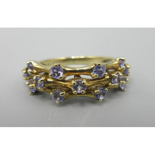 10 - 9ct yellow gold three band ring set with pale blue stones, stamped 9k, size L1/2, 2.7g