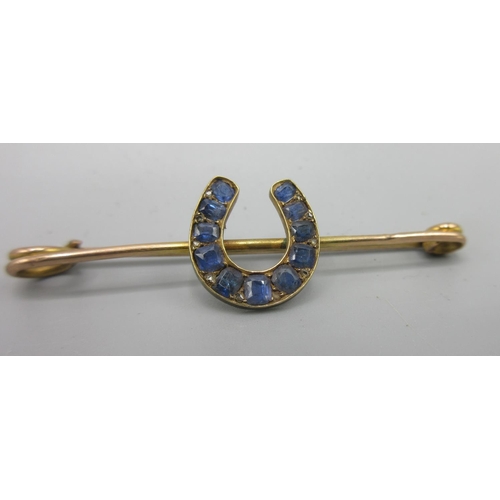 33 - 9ct yellow gold bar brooch set with sapphires in horseshoe design, stamped 375, approx. L5.5cm