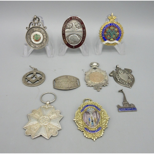 44 - Collection of Sterling silver badges and fobs including two gilded and enamel fobs, a North Derbyshi... 