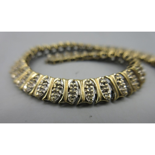 51 - Yellow metal articulated bracelet set with diamonds, AF, unmarked, 10.7g