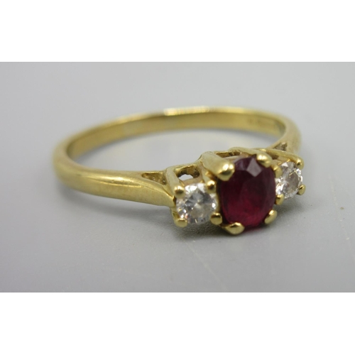 54 - 18ct yellow gold ring set with central ruby flanked by diamonds, stamped 750, size M, 2.45g