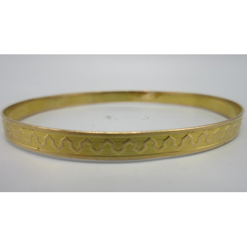 8 - Yellow metal bangle, unmarked, with engraved design, 8.6g