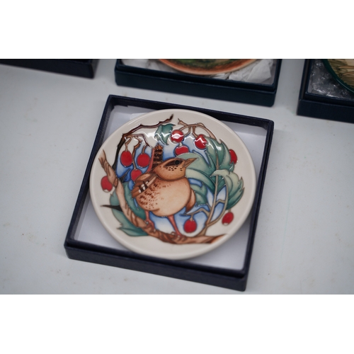 304 - Four Moorcroft pin dishes with boxes, incl. a pin dish featuring a bird surrounded by red berries an... 