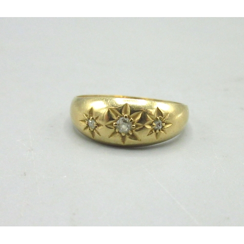 490 - 18ct yellow gold gypsy ring set with three diamonds in star cut settings, stamped 18, 2.87g