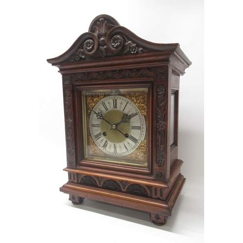 766 - Reinhold Schnekenburger, 20th Century walnut mantle clock, carved case with bevel edged door enclosi... 