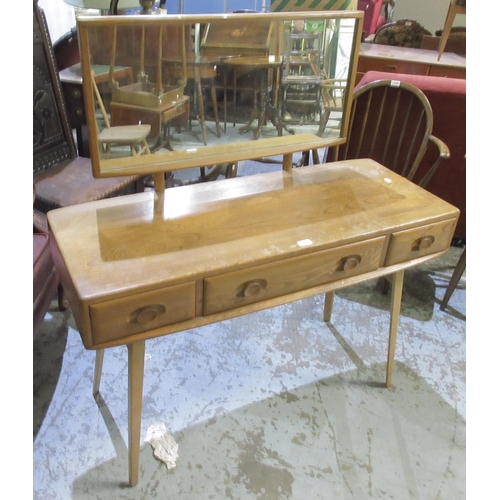 603 - Ercol light elm dressing table, adjustable mirror above three drawers, two with glass slides, on spl... 