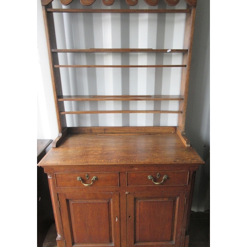 572 - Early 20th century light oak dresser, twin shelf back with scroll frieze above two drawers and doors... 