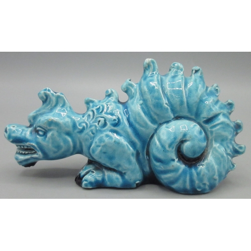 1148 - Burmantofts turquoise glazed Faience model of a crouching dragon, model No 1166