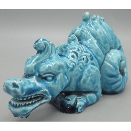 1148 - Burmantofts turquoise glazed Faience model of a crouching dragon, model No 1166