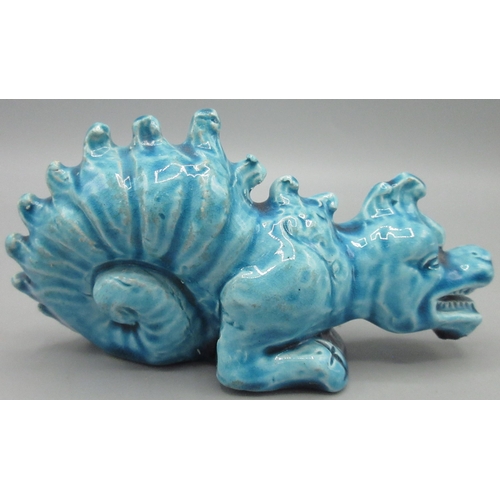 1148 - Burmantofts turquoise glazed Faience model of a crouching dragon, model No 1166