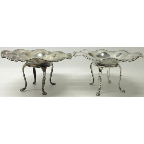 1069 - Pair of Edwardian silver bonbon dishes, scrolling borders with foliate repoussé, on four cabriole le... 