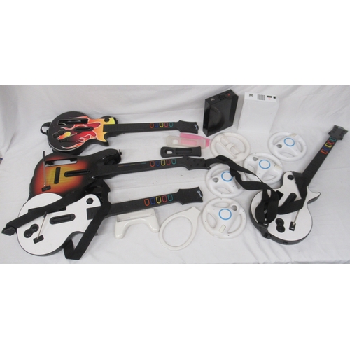 599 - Nintendo Wii - 2 consoles, various controller covers, 4 Guitar Hero guitar covers, 53 Wii games, etc... 