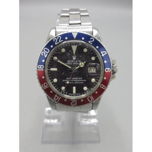 Rolex Oyster Perpetual GMT-Master stainless steel automatic wristwatch with date on matching riveted oyster bracelet with signed deployment clasp, signed black dial, dot and baton indices with centre seconds, bidirectional Pepsi bezel, signed crown, Rolex ref. no. 1675 serial no. 1637428, D39.5mm