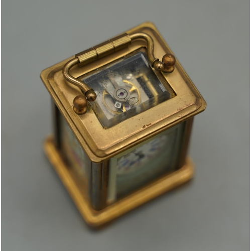 1398 - 20th century French brass 8 day miniature carriage timepiece, plain case set with Serves style flora... 