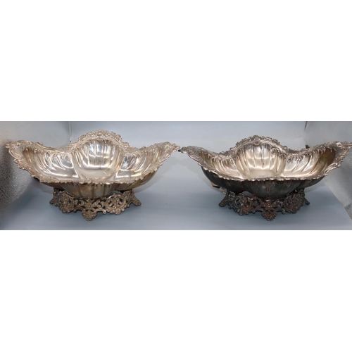 1065 - Pair of Victorian shaped fluted oval silver bowls, with repousse Rococo shell and shell border, on p... 