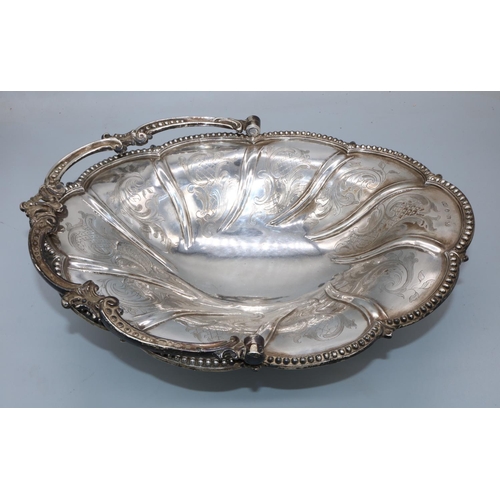 1068 - Victorian silver oval swing handled basket, engraved with C scrolls with beaded border and similar h... 