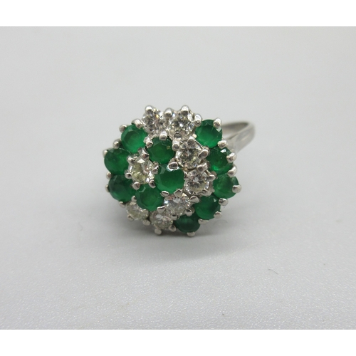 1023 - 18ct white gold diamond and emerald cluster ring, set with eleven brilliant cut sapphires and eight ... 