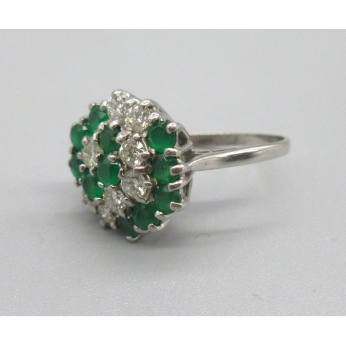 1023 - 18ct white gold diamond and emerald cluster ring, set with eleven brilliant cut sapphires and eight ... 