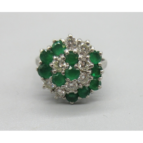 1023 - 18ct white gold diamond and emerald cluster ring, set with eleven brilliant cut sapphires and eight ... 