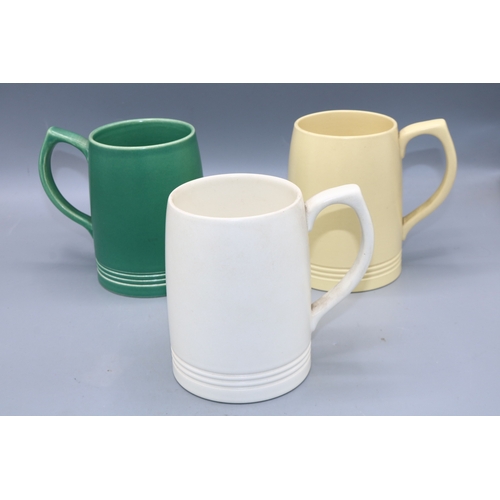 1194 - Keith Murray for Wedgwood, collection of tankards with incised decoration, in moonstone white, green... 