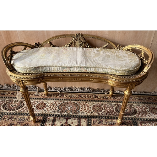 1558 - Late 19th century French giltwood shaped oval window seat, with ribbon tied floral swag pierced hand... 