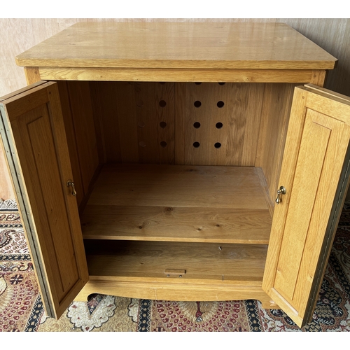 1548 - Geoff Unicornman Gell, Coxwold Cabinet Makers - an oak TV cabinet, with two panel doors, carved with... 