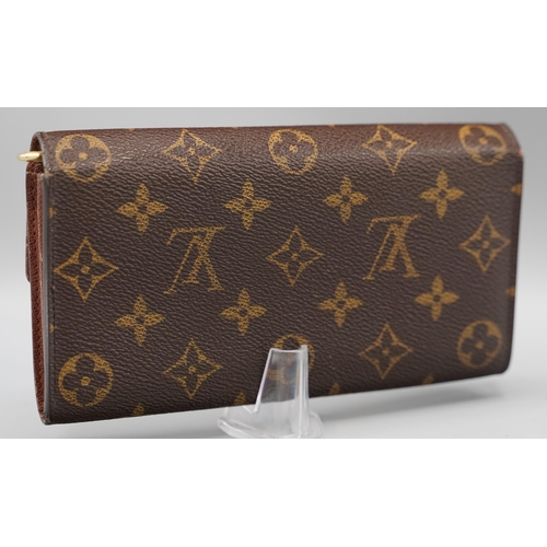 1432 - Louis Vuitton 'Sarah' wallet in brown monogram canvas with gold coloured hardware, flap with press s... 