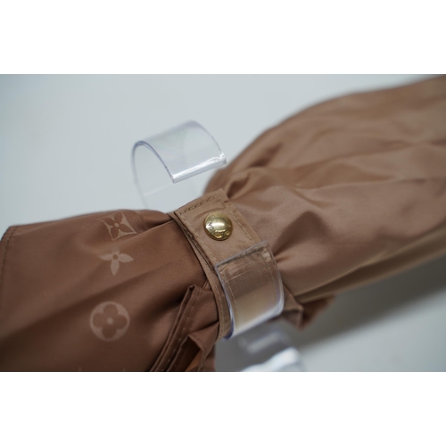 1430 - Louis Vuitton umbrella in a rose gold/beige tone, monogram pattern to rim, with leather handle and g... 