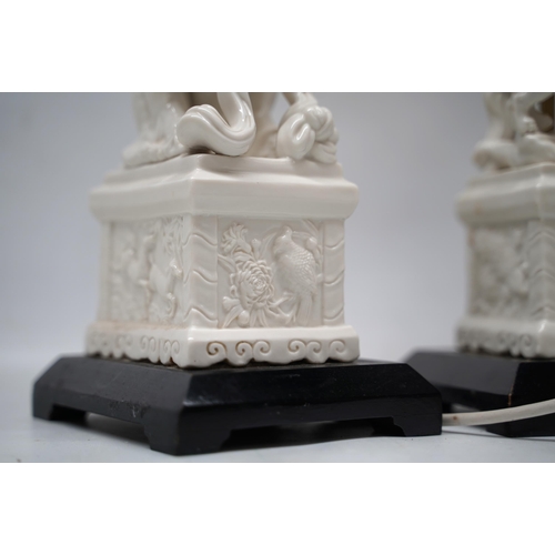 1241 - Pair of Blanc de Chine style table lamps modelled as Dog of Fo groups on rectangular plinths and ebo... 