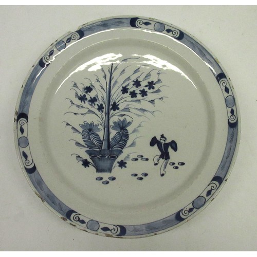 1158 - 18th century English delftware circular dish, decorated with a dancing figure and a tree with a repe... 