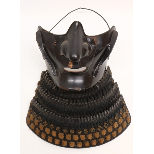 1354 - Japanese black lacquered Samurai armour menpo lower face mask, with three-section layered yodarekake... 