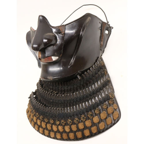 1354 - Japanese black lacquered Samurai armour menpo lower face mask, with three-section layered yodarekake... 