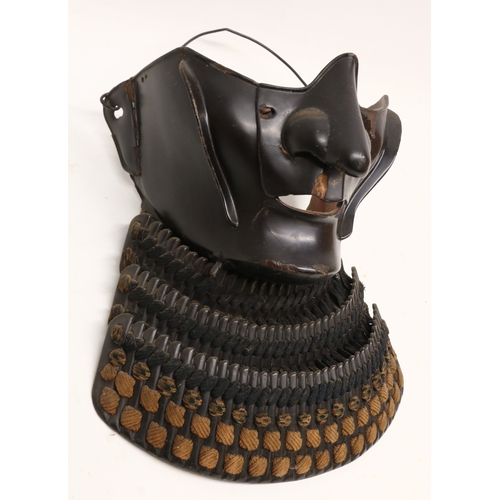 1354 - Japanese black lacquered Samurai armour menpo lower face mask, with three-section layered yodarekake... 