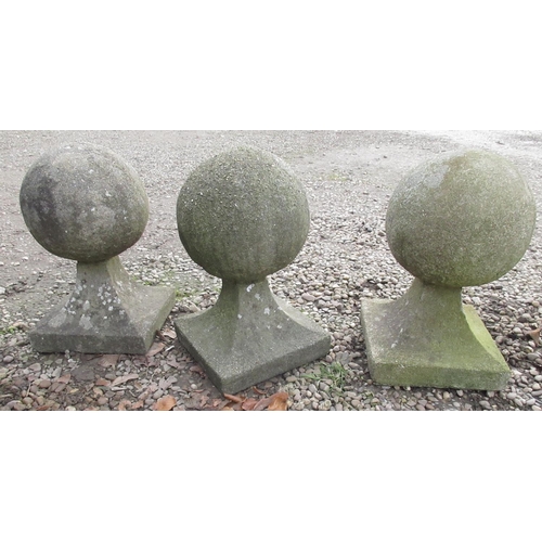 1707 - Set of three weathered composite stone spherical gatepost finials, on tapered square bases, W35cm D3... 