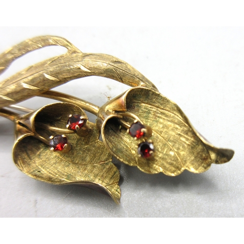 3 - 9ct yellow gold brooch in the form of two flowers set with garnet, stamped 9ct, 5.87g

Shipping £23.... 