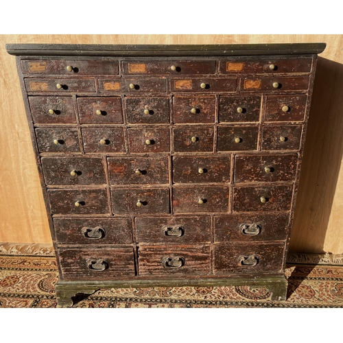 1559 - Victorian painted pine bank of thirty-three various drawers, top seven fitted, moulded top and on br... 