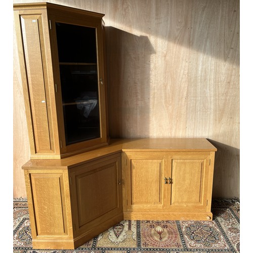 1531 - Geoff Unicornman Gell, Coxwold Cabinet Makers - a panelled oak corner unit, with glazed cabinet abov... 