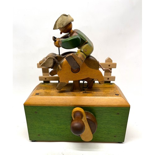 1255 - Hand made painted wooden automaton of a farmer riding a pig, on rectangular base, signed Nic, 90 Mad... 