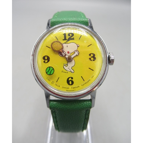 239 - Timex, Great Britain - 'Snoopy playing tennis' chrome wristwatch, yellow dial with Arabic and baton ... 