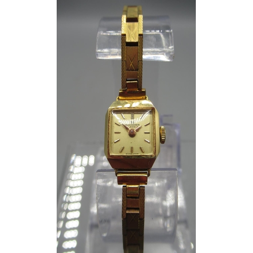 245 - Bucherer lady's 18ct gold wristwatch on gold plated box link bracelet, signed champagne dial with ba... 