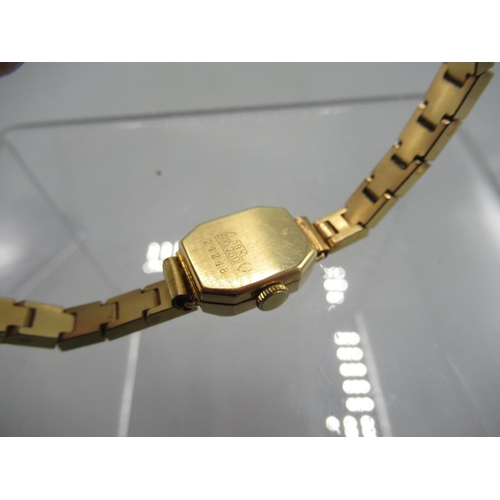 245 - Bucherer lady's 18ct gold wristwatch on gold plated box link bracelet, signed champagne dial with ba... 