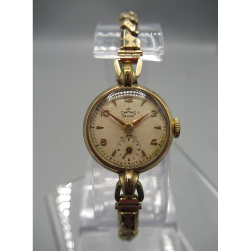 247 - Smiths De Luxe lady's gold plated wristwatch on gold plated expanding bracelet, signed silvered dial... 