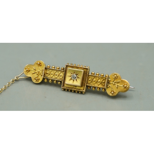 132 - 15ct yellow gold Etruscan style bar brooch set with central diamond, stamped 15ct, 4.66g

Shipping £... 