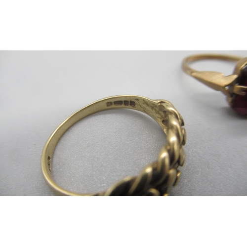 54 - Two 9ct yellow gold rings set with red stones, size N1/2 and K, and a 9ct yellow gold keeper ring, s... 