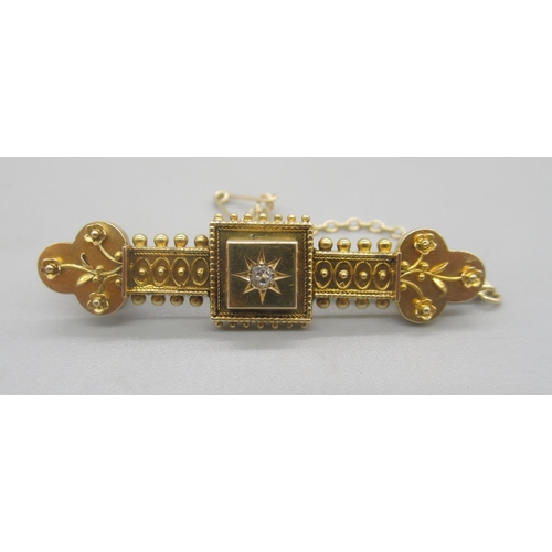 132 - 15ct yellow gold Etruscan style bar brooch set with central diamond, stamped 15ct, 4.66g

Shipping £... 