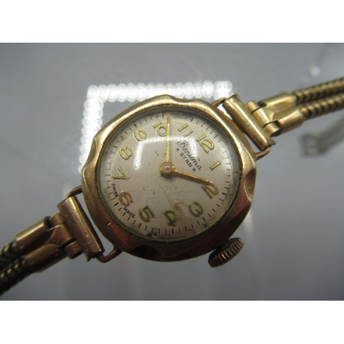 256 - Bentima Star lady's 9ct gold wristwatch on gold plated strap, signed champagne Arabic dial, hinged c... 