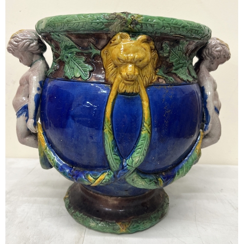 186 - Minton style majolica jardiniere with moulded cherubs and lion masks, lozenge to underside, H26cm