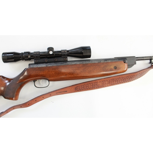 634 - Weihrauch HW 80 .22 break barrel air rifle. With Tasco scope, leather sling, gun slip, and a tin of ... 